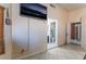 A main bedroom featuring a TV and doorways leading to the bathroom and hallway at 6224 Mandarin Dr, Las Vegas, NV 89108