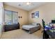 Cozy bedroom with neutral tones, a window view, and comfortable furnishings at 6308 Lauren Ashton Ave, Las Vegas, NV 89131