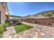 Backyard featuring brick pavers, outdoor seating, lush greenery, and a small grass area at 6461 Mount Eden Ave, Las Vegas, NV 89139