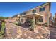 This backyard has a covered patio, brick pavers, and a well-kept lawn at 6461 Mount Eden Ave, Las Vegas, NV 89139