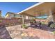 Relax in this backyard with a covered patio, brick pavers, and lush greenery at 6461 Mount Eden Ave, Las Vegas, NV 89139