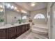 Bathroom with double sinks, large mirrors, soaking tub, and plenty of counter space at 6461 Mount Eden Ave, Las Vegas, NV 89139