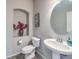 Powder room featuring a pedestal sink, oval mirror, and decorative accents at 6461 Mount Eden Ave, Las Vegas, NV 89139