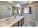 Bathroom featuring a double sink vanity, large mirror, and walk-in shower at 6461 Mount Eden Ave, Las Vegas, NV 89139
