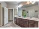 Bathroom featuring double sinks, modern fixtures, and ample storage with an open door at 6461 Mount Eden Ave, Las Vegas, NV 89139