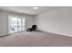 Bright bedroom features neutral carpet and sliding glass door to balcony at 6461 Mount Eden Ave, Las Vegas, NV 89139