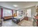 Comfortable bedroom with natural light, neutral walls, wood-look flooring, and tasteful decor at 6461 Mount Eden Ave, Las Vegas, NV 89139
