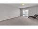 Spacious bedroom with neutral carpet and sliding glass door to a balcony at 6461 Mount Eden Ave, Las Vegas, NV 89139