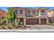 Attractive two-story home featuring a well-manicured front yard and attached two-car garage at 6461 Mount Eden Ave, Las Vegas, NV 89139