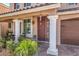 Covered front porch with decorative columns and an iron security door for added curb appeal at 6461 Mount Eden Ave, Las Vegas, NV 89139