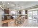 Spacious kitchen with a large island, pendant lighting, dark wood cabinets, and stainless steel appliances at 6461 Mount Eden Ave, Las Vegas, NV 89139