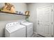 Functional laundry room featuring washer, dryer, and shelving storage at 6461 Mount Eden Ave, Las Vegas, NV 89139