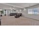 Spacious living room with neutral carpet and recessed lights, with a leather sofa, chair and side tables at 6461 Mount Eden Ave, Las Vegas, NV 89139