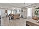 Bright living room with hardwood floors, fireplace, neutral decor, and chandelier at 6461 Mount Eden Ave, Las Vegas, NV 89139