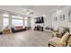 Inviting living room with large windows, stylish furnishings, and a neutral color palette at 6461 Mount Eden Ave, Las Vegas, NV 89139