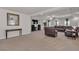Expansive living room featuring neutral carpet, recessed lights, a ceiling fan, and a large leather sectional at 6461 Mount Eden Ave, Las Vegas, NV 89139