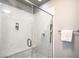 Modern glass-enclosed shower with marble-look walls and built-in bench at 6461 Mount Eden Ave, Las Vegas, NV 89139