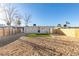 Spacious backyard featuring desert landscaping and a patch of green turf at 704 Stanford St, Las Vegas, NV 89107