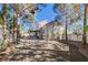Expansive backyard with mature trees, a covered patio and a fire pit ring at 7624 Nocturne Ct, Las Vegas, NV 89128