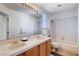 Bright bathroom featuring double sinks, tiled countertops, and a shower-tub combo with white tiling at 7624 Nocturne Ct, Las Vegas, NV 89128