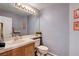 Cozy powder room featuring a large mirror, vanity with sink, and classic fixtures at 7624 Nocturne Ct, Las Vegas, NV 89128