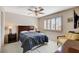 Cozy bedroom featuring a ceiling fan, shuttered windows, and comfortable furniture at 7624 Nocturne Ct, Las Vegas, NV 89128