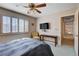 This bedroom has a window with shutters and a view to the hallway for good natural light at 7624 Nocturne Ct, Las Vegas, NV 89128