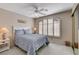 Bedroom features a bed with blue bedding and shuttered window with arched top at 7624 Nocturne Ct, Las Vegas, NV 89128