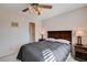 Bedroom with a ceiling fan, queen bed, side tables, and a walk-in closet for ample storage at 7624 Nocturne Ct, Las Vegas, NV 89128