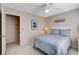 Bedroom with blue bedding, shuttered window, and door to hallway at 7624 Nocturne Ct, Las Vegas, NV 89128