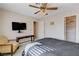 Bedroom with seating area, mounted television, and closet, offering comfort and convenience at 7624 Nocturne Ct, Las Vegas, NV 89128