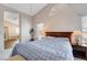 Airy bedroom featuring an adjacent bathroom with an alcove bathtub at 7624 Nocturne Ct, Las Vegas, NV 89128