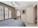 Bright bedroom with plantation shutters, double bed, mirrored closet, and doorway access at 7624 Nocturne Ct, Las Vegas, NV 89128