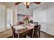 Dining area with a ceiling fan and a living room view with fireplace at 7624 Nocturne Ct, Las Vegas, NV 89128