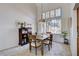 Charming dining area featuring a modern light fixture, plantation shutters, and natural light at 7624 Nocturne Ct, Las Vegas, NV 89128