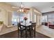 Dining area with natural light from windows and doors, carpet and hardwood flooring at 7624 Nocturne Ct, Las Vegas, NV 89128