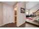 Inviting entryway with wood floors leading to a cozy living room, adjacent to a convenient half bathroom at 7624 Nocturne Ct, Las Vegas, NV 89128