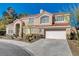 Attractive two-story home showcasing a red tile roof, desert landscaping, and an attached two-car garage at 7624 Nocturne Ct, Las Vegas, NV 89128