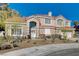 Inviting two-story home featuring a red tile roof, desert landscaping, and a bright and airy facade at 7624 Nocturne Ct, Las Vegas, NV 89128