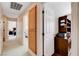 Hallway with carpet floors leads to bedrooms, features a storage cabinet and built-in desk space at 7624 Nocturne Ct, Las Vegas, NV 89128