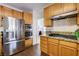 Efficient kitchen with wood cabinets, granite counters and stainless steel appliances at 7624 Nocturne Ct, Las Vegas, NV 89128