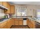 Bright kitchen with granite counters, stainless steel sink, and open layout to the dining space at 7624 Nocturne Ct, Las Vegas, NV 89128