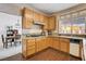 Charming kitchen with granite counters, wood cabinets, and open access to the dining area at 7624 Nocturne Ct, Las Vegas, NV 89128