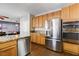 Bright kitchen with stainless steel appliances, granite countertops, and ample cabinet space at 7624 Nocturne Ct, Las Vegas, NV 89128