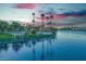 Scenic lakefront view with palm trees and walking path at sunset at 7624 Nocturne Ct, Las Vegas, NV 89128