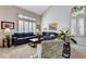 Comfortable living area with neutral tones and large windows at 7624 Nocturne Ct, Las Vegas, NV 89128