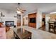 Open concept living room featuring a fireplace, built-in bookcase, and access to the kitchen at 7624 Nocturne Ct, Las Vegas, NV 89128