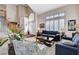 Inviting living room featuring vaulted ceilings, a staircase, and large windows with plantation shutters at 7624 Nocturne Ct, Las Vegas, NV 89128