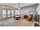 Bright living room with a fireplace, carpet, and a pair of doors to the backyard at 7624 Nocturne Ct, Las Vegas, NV 89128