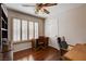 Office with wooden desk, ceiling fan, shutters, and hardwood floors at 7624 Nocturne Ct, Las Vegas, NV 89128
